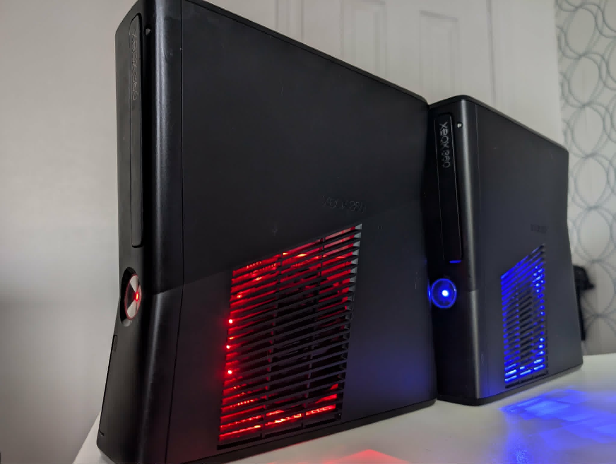 Two modded Xbox 360 consoles with red and blue LED fan lighting